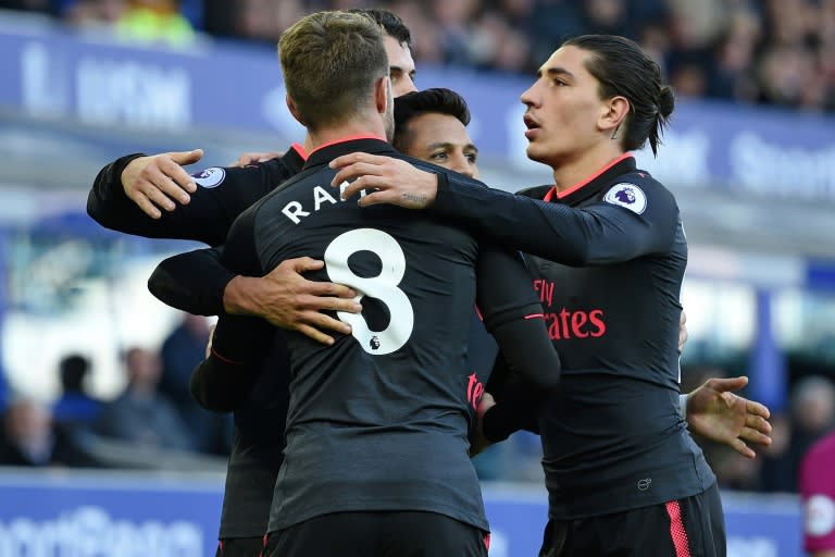 Arsenal's Chilean striker Alexis Sanchez (C) celebrates with teammates after scoring a goal during their English Premier League match against Everton, at Goodison Park in Liverpool, on October 22, 2017