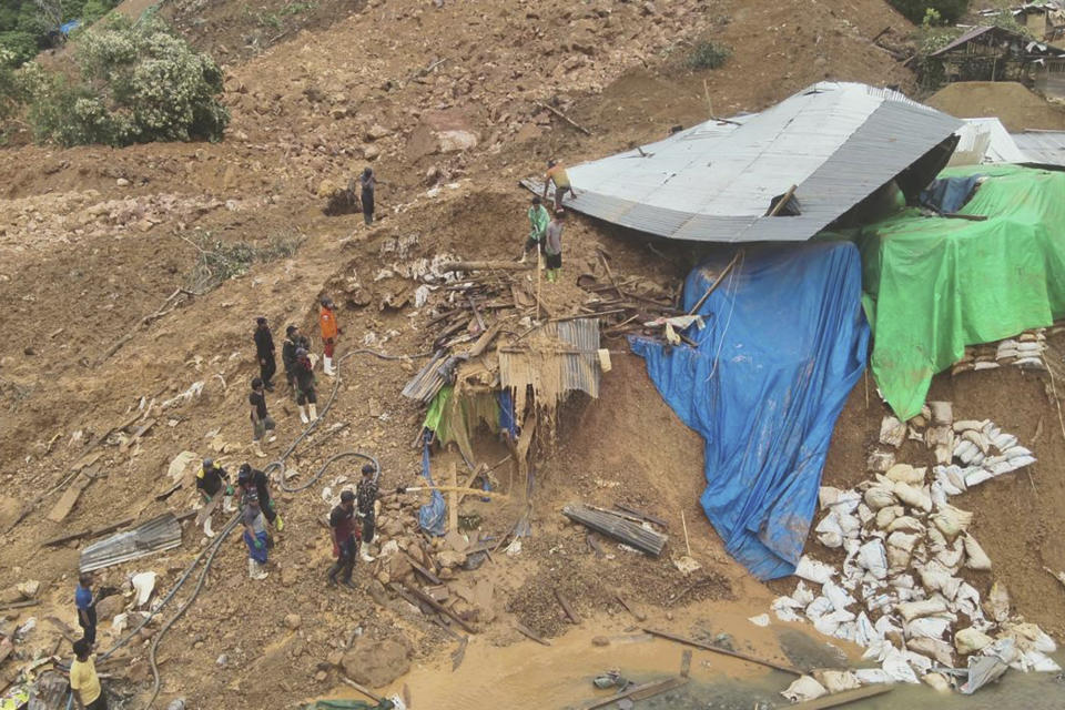 In this photo released by the Indonesian National Search and Rescue Agency (BASARNAS), rescuers search for victims at the site of a landslide in Bone Bolango in Gorontalo province, Indonesia, Wednesday, July 10, 2024. Search efforts for those trapped in a deadly landslide intensified Wednesday, with more rescuers deployed to search an unauthorized gold mine on Indonesia's Sulawesi island that saw a number of deaths over the weekend. (BASARNAS via AP)