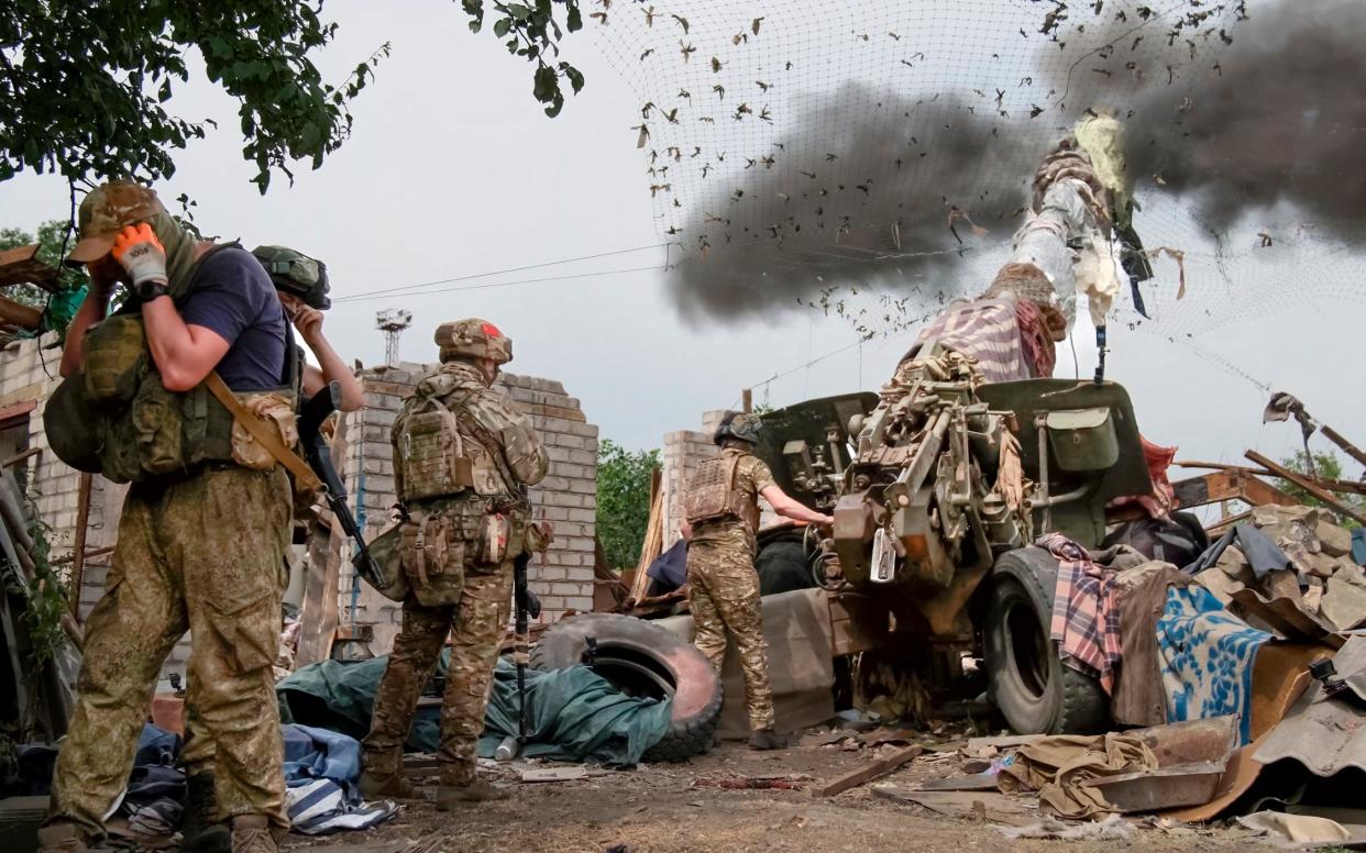 Russian soldiers fire the 152-mm howitzer 'Msta-B' in an undisclosed location in Ukraine on June 25