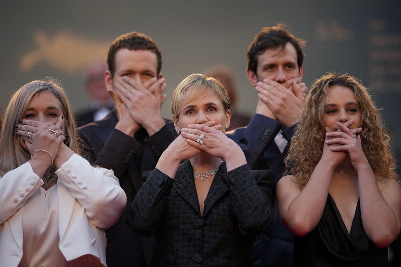 "Me Too" director Judith Godreche, center, poses with hands covering their mouth upon arrival at the premiere of the film 'Furiosa: A Mad Max Saga'