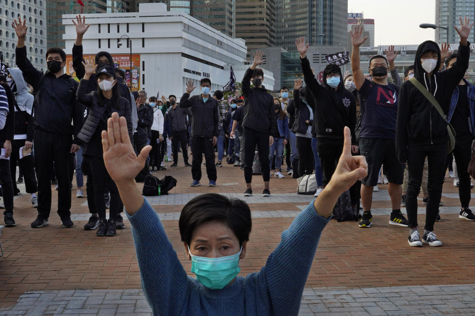 Protesters raise five demands gestures during a rally in Hong Kong, Sunday, Jan. 12, 2020. More than a thousand people attended a Sunday rally in Hong Kong to urge people and governments abroad to support the territory's pro-democracy movement and oppose China's ruling Communist Party. (AP Photo/Vincent Yu)