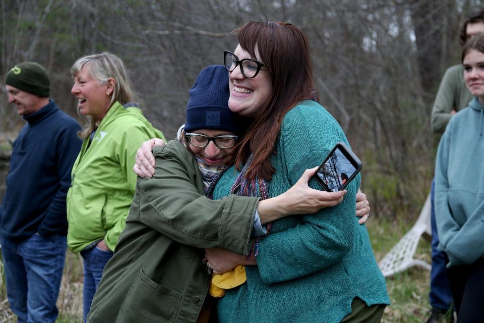 From left, Center for Wildlife volunteer Joanne Francis and Executive Director Kristen Lamb celebrate after releasing the injured snapping turtle back into the wild on Tuesday, April 26, 2022.