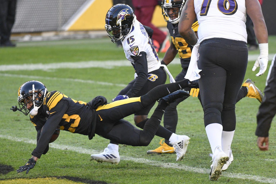 Pittsburgh Steelers cornerback Joe Haden (23) dives into the end zone in front \of Baltimore Ravens wide receiver Marquise Brown (15) with a touchdown after intercepting a pass during the first half of an NFL football game, Wednesday, Dec. 2, 2020, in Pittsburgh. (AP Photo/Don Wright)