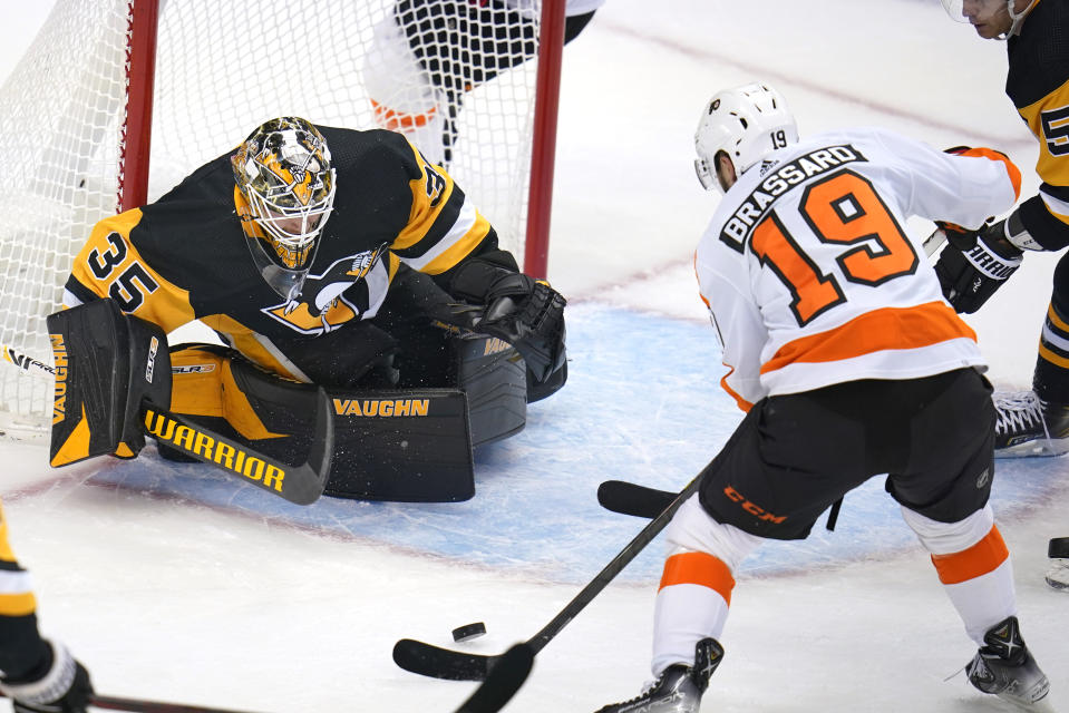 Pittsburgh Penguins goaltender Tristan Jarry blocks a shot attempt by Philadelphia Flyers' Derick Brassard (19) during the first period of an NHL hockey game in Pittsburgh, Thursday, Nov. 4, 2021. (AP Photo/Gene J. Puskar)