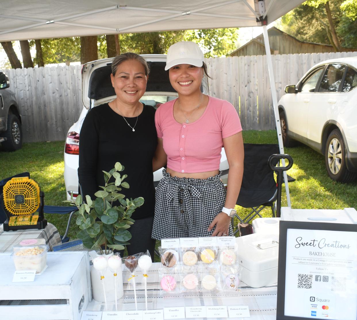 Thi Truong (left) helps her daughter Amy Tra (right), owner of Sweet Creations Bakehouse, sell baked goods. Tra specializes in making macaroons but she also makes cake pops, chocolates chip cookies, custom cakes, cupcakes and other desserts.