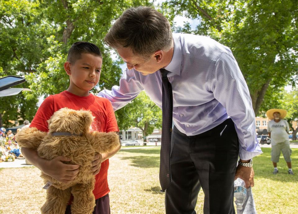 State Sen. Roland Gutierrez, D-San Antonio, talks to Leon Hernandez, 9, in Uvalde in June 2022, days after the third grader survived the mass shooting. Gutierrez has remained steadfast in his support for the victims' families and the fight for stricter gun laws.