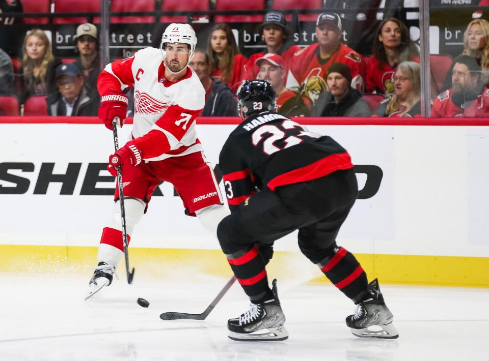 Red Wings forward Dylan Larkin skates with the puck against the Senators' Travis Hamonic in the first period on Saturday, Oct. 21, 2023, in Ottawa.