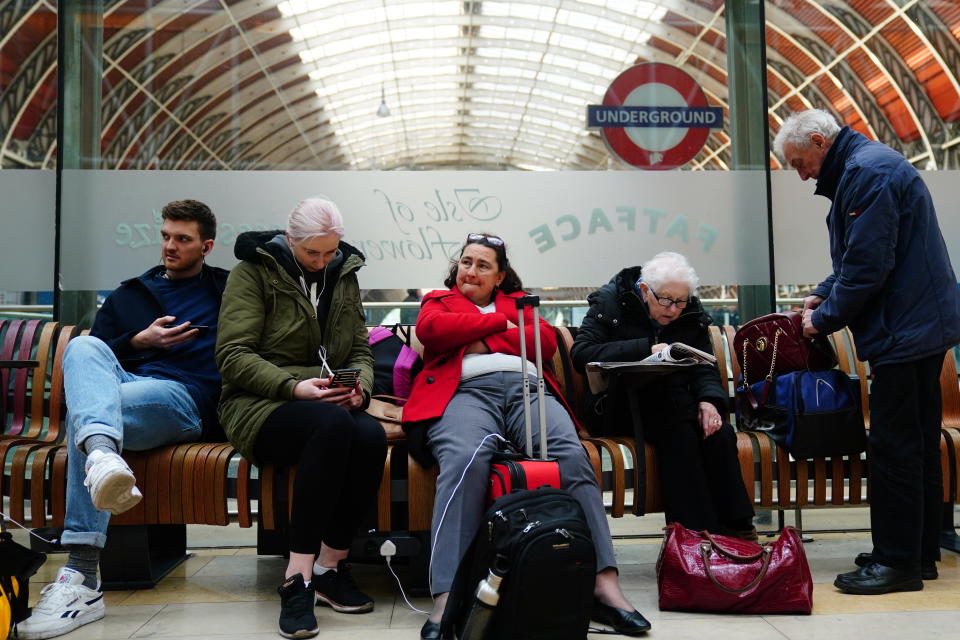 Passengers at Paddington station in London where trains were cancelled due to Storm Eunice. (PA)