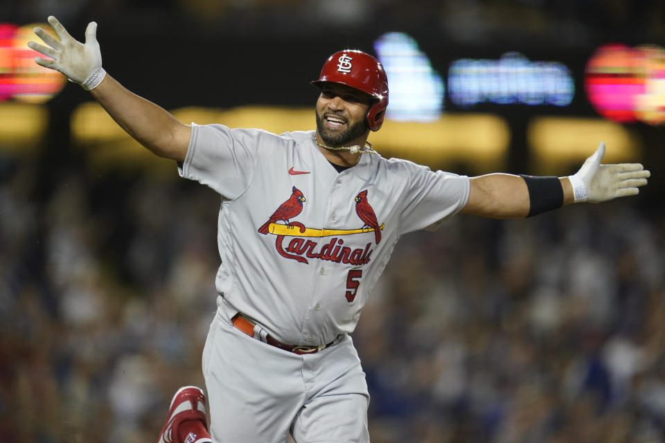 FILE - St. Louis Cardinals designated hitter Albert Pujols (5) reacts after hitting his 700th home run during the fourth inning of a baseball game against the Los Angeles Dodgers in Los Angeles on Sept. 23, 2022. Pujols said Thursday, March 9, 2023, he believes he will eventually return to baseball as a coach during a stop at St. Louis Cardinals' camp.(AP Photo/Ashley Landis, File)