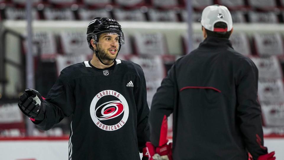 Carolina Hurricanes’s Tony DeAngelo (77) talks with coach Rod Brind’Amour during practice on Friday, May 13, 2022 as they prepare for game seven in the Stanley Cup first round series against Boston at PNC Arena in Raleigh, N.C.
