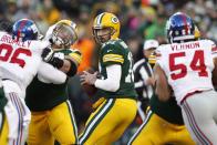 <p>Green Bay Packers quarterback Aaron Rodgers (12) drops back to pass against the New York Giants during the first quarter in the NFC Wild Card playoff football game at Lambeau Field. Mandatory Credit: Jeff Hanisch-USA TODAY Sports </p>