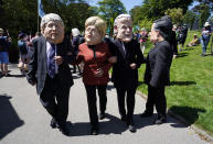 Activists dressed in giant papier-mache heads depicting G7 leaders participate in a march during a demonstration around the meeting of the G7 in Falmouth, Cornwall, England, Saturday, June 12, 2021. Leaders of the G7 gather for a second day of meetings on Saturday, in which they will discuss COVID-19, climate, foreign policy and the economy. (AP Photo/Alberto Pezzali)