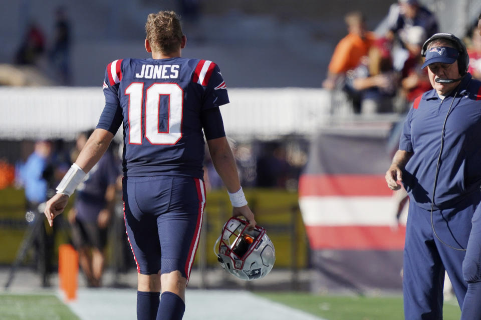 New England Patriots quarterback Mac Jones (10) walks off the field past head coach Bill Belichick late in the second half of an NFL football game against the New Orleans Saints, Sunday, Sept. 26, 2021, in Foxborough, Mass. (AP Photo/Mary Schwalm)