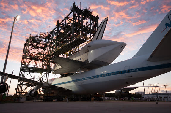 Space shuttle Endeavour is seen at the Kennedy Space Center in Florida atop NASA's modified Boeing 747 Shuttle Carrier Aircraft (SCA) at sunrise on Sunday, Sept. 16, 2012.