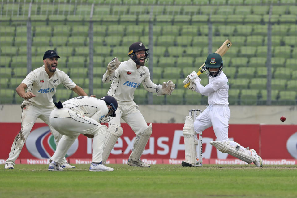 New Zealand Players celebrate the dismissal of Bangladesh's Mominul Haque during the fourth day of the second test cricket match between Bangladesh and New Zealand in Dhaka, Bangladesh, Saturday, Dec. 9, 2023. (AP Photo/Mosaraf Hossain)