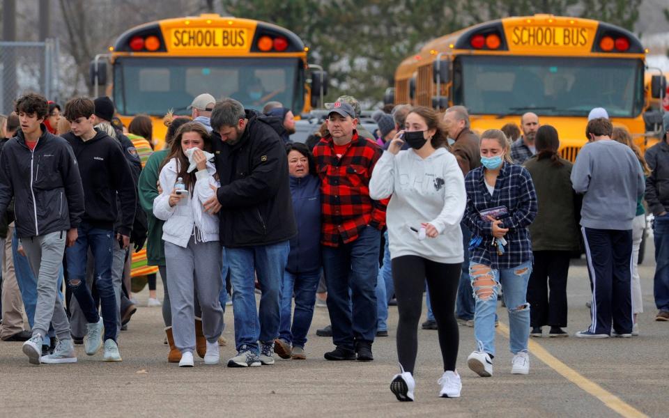 Parents and children gather following the active shooter situation at Oxford High School - Reuters