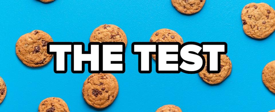 Chocolate chip cookies on a blue background with the text "The Test" in bold letters across the center of the image