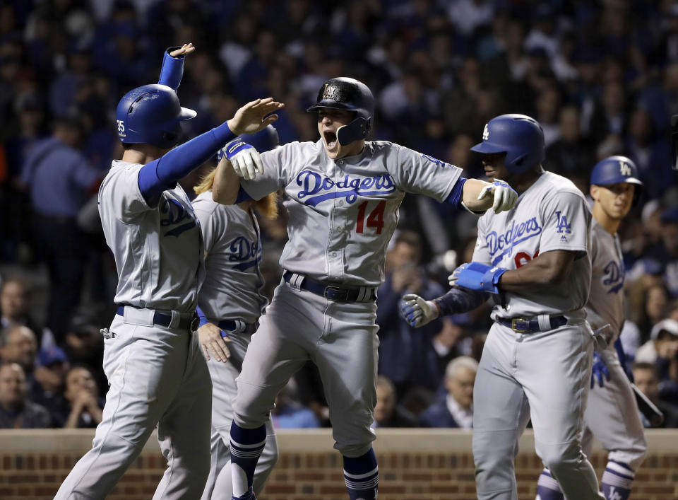 Enrique Hernandez (14) celebrates after hitting a grand slam during the third inning of Game 5 of the NLCS. (AP)