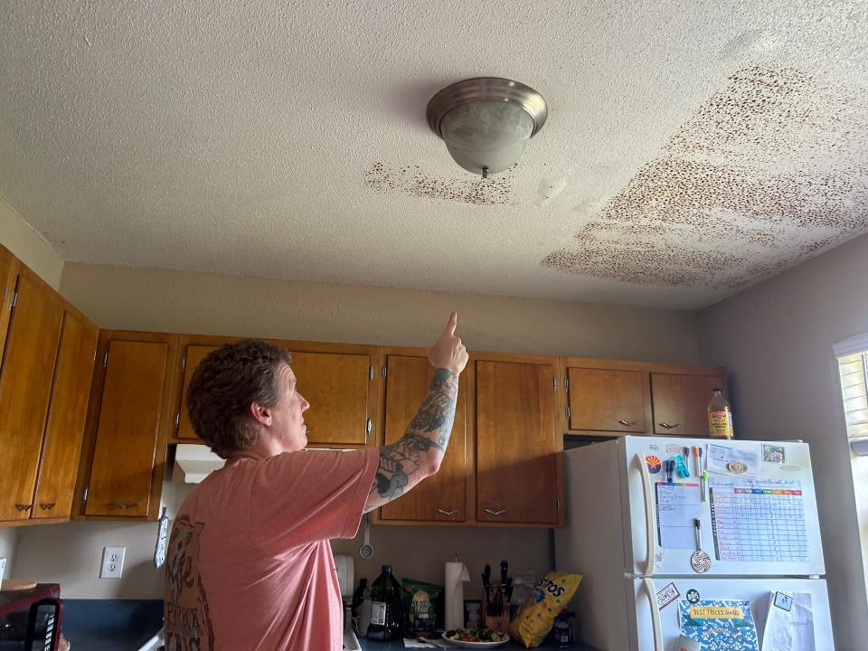 Suzanne Stafford pointing to the water stain on her ceiling from Tallahassee's May 10, 2024, storm.