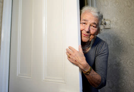 FILE PHOTO: British children's writer and illustrator Judith Kerr peers around a door as she recreates a scene from her bestselling picture book "The Tiger Who Came To Tea", at her home in west London, Britain September 30, 2015. REUTERS/Dylan Martinez/File Photo