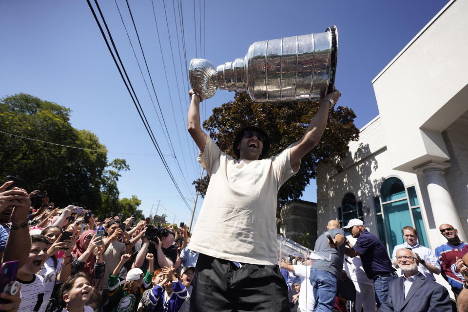 NHL player Nazem Kadri hoist the Stanley Cup in front of the London Muslim Mosque in London, Ontario on Saturday Aug. 27, 2022. Kadri, 31, won the cup for the first time while playing with the Colorado Avalanche. (Geoff Robins /The Canadian Press via AP)