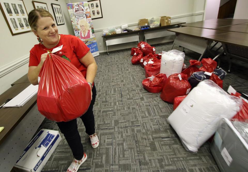 Janet LaMere pulls another wish sack for the Senior Christmas Wish program at the United Way offices on East Franklin Boulevard Tuesday morning, Dec. 12, 2023.