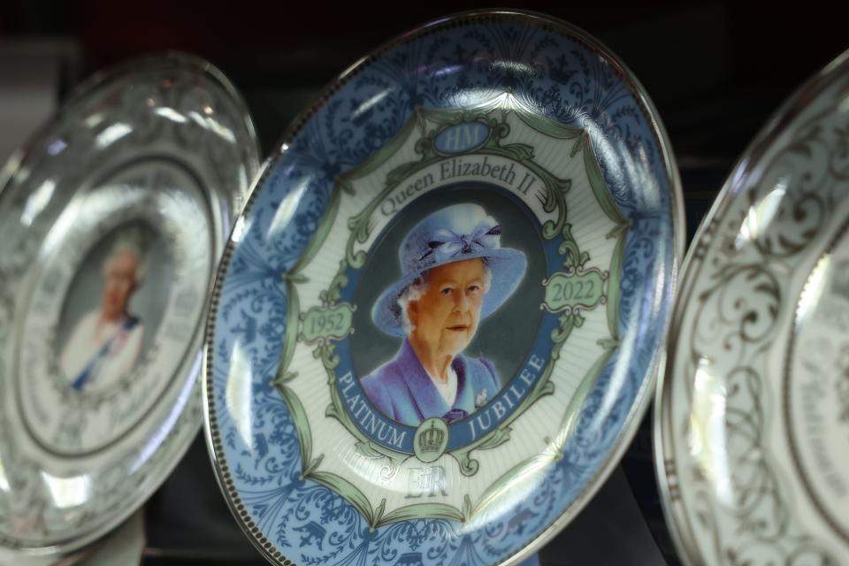 A souvenir plate in a London shop, featuring an image of Queen Elizabeth II, touts her Platinum Jubilee.