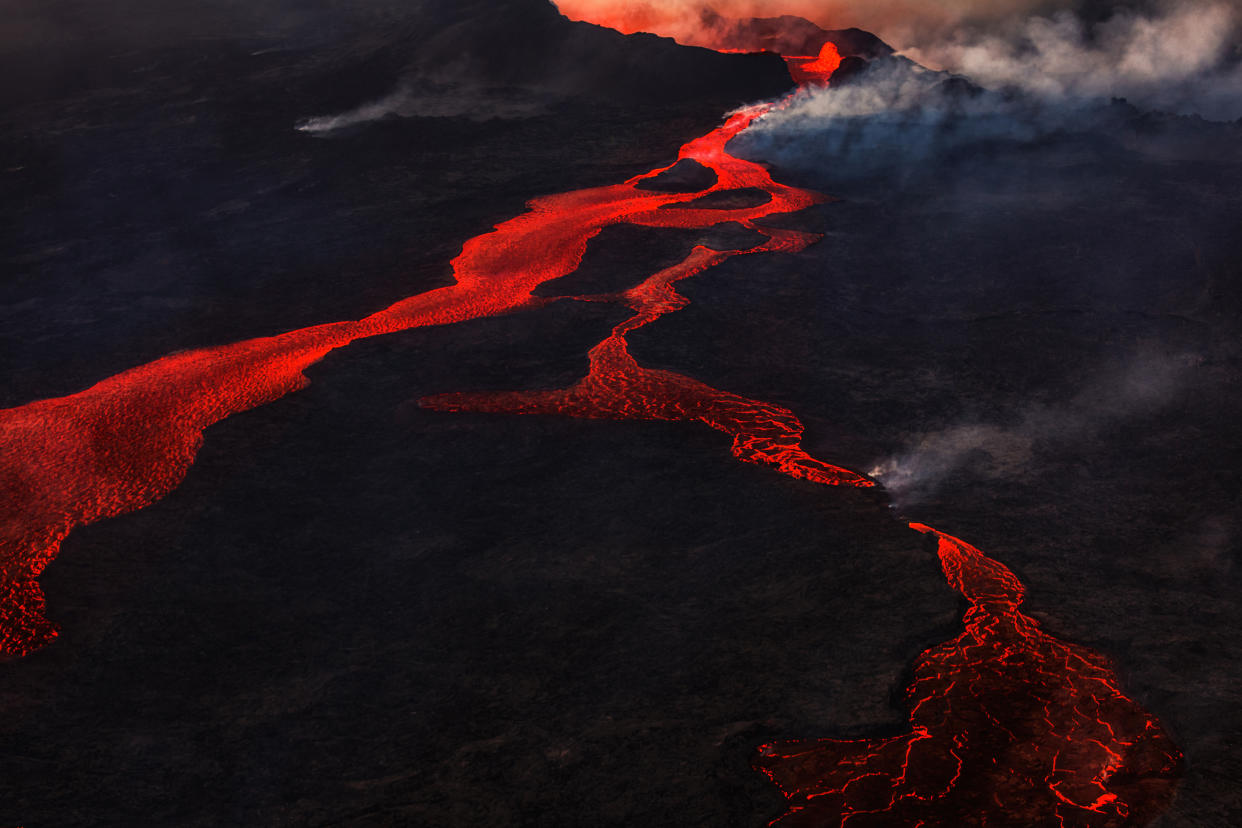 Lava and plumes from the Holuhraun Fissure Eruption by the Bardarbunga Volcano, Iceland. On August 29, 2014, a fissure eruption started in Holuhraun at the northern end of a magma intrusion that had moved progressively north, from the Bardarbunga volcano. Bardarbunga is a stratovolcano located under Vatnajokull, Iceland's most extensive glacier.