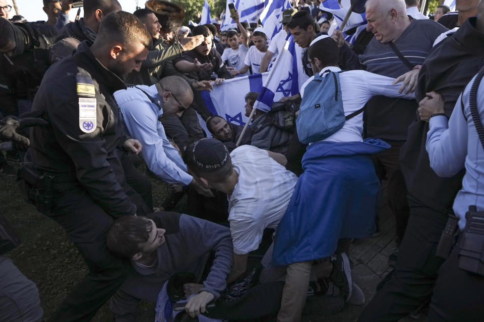 Israeli police officer block right wing activists from marching towards the Old City in Jerusalem, Wednesday, April 20, 2022. Police prevented hundreds of ultra-nationalist Israelis from marching around predominantly Palestinian areas of Jerusalem's Old City. The event planned for Wednesday was similar to one that served as one of the triggers of last year's Israel-Gaza war. (AP Photo/Ariel Schalit)