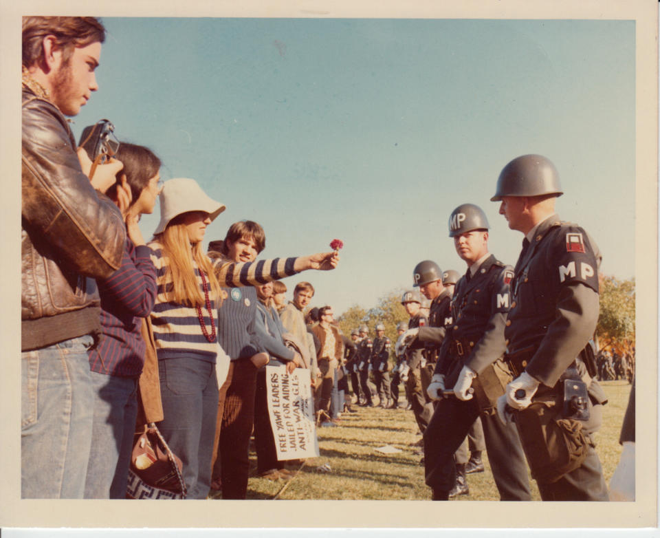 A female demonstrator offers a flower to military police on guard at the Pentagon on Oct. 21, 1967.