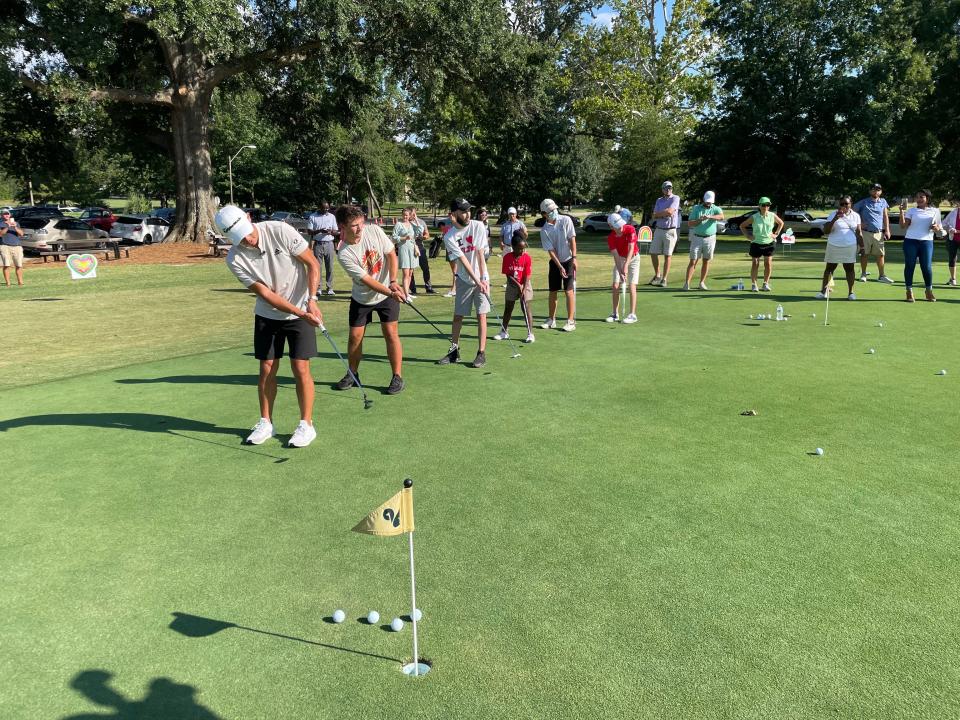 Collin Morikawa and five St. Jude patients take part in a putting contest as part of a golf clinic at the Overton Park 9 in conjunction with the 2022 FedEx St. Jude Championship.