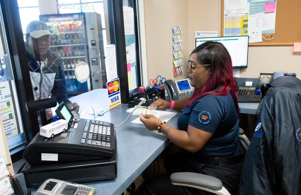 Escambia County Area Transit Customer Service Representative Richetta Nichols completes a ticket purchase for a rider on Thursday, March 30, 2023. The ECAT workers haven’t had a permanent labor contract since Escambia County took over the day-to-day operations of the bus system in 2017.