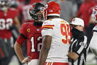 Tampa Bay Buccaneers quarterback Tom Brady (12) exchanges words with Kansas City Chiefs defensive tackle Chris Jones (95) as referee Shawn Hochuli (83) tries to separate the two during the second half of an NFL football game Sunday, Nov. 29, 2020, in Tampa, Fla. (AP Photo/Jason Behnken)
