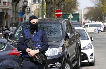 Belgium police officers secure the access during a police operation in Etterbeek, near Brussels, Belgium, April 9, 2016. REUTERS/Yves Herman