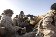 A Yemeni fighter backed by the Saudi-led coalition prepares to fire his weapon during clashes with Houthi rebels on the Kassara frontline near Marib, Yemen, Sunday, June 20, 2021. (AP Photo/Nariman El-Mofty)