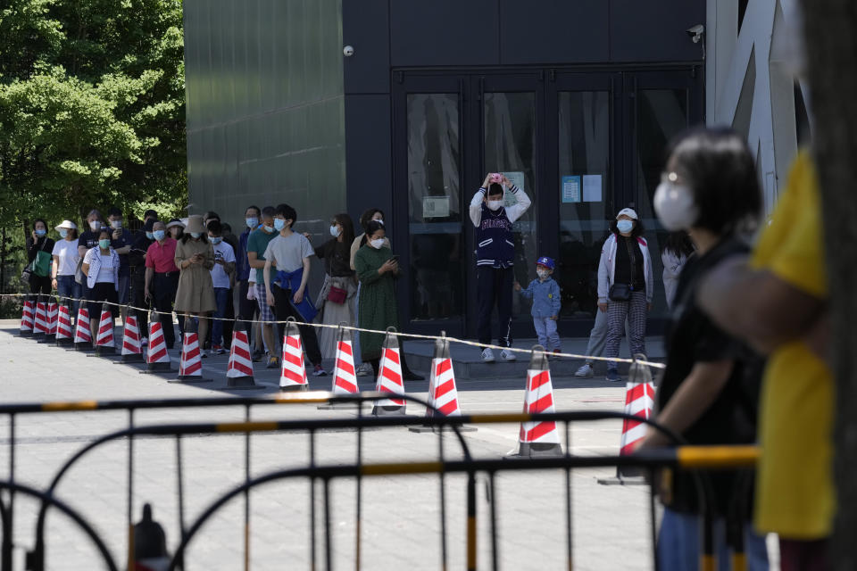 Residents line up for COVID mass testing site on Sunday, May 15, 2022, in Beijing. (AP Photo/Ng Han Guan)