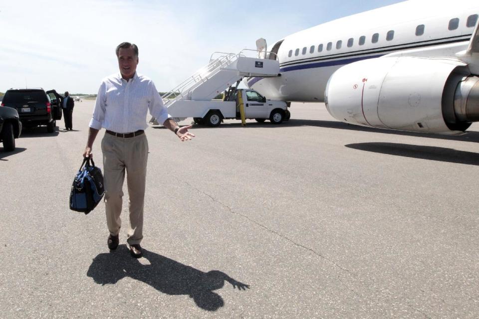 Republican presidential candidate, former Massachusetts Gov. Mitt Romney gestures as he speaks to reporters on the tarmac after arriving in Manchester, N.H., Friday, May 18, 2012. (AP Photo/Mary Altaffer)