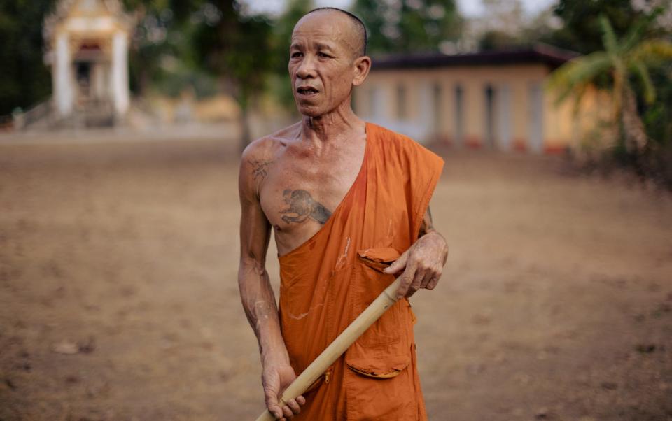 Buddhist monk Prasert Sriwauria, 60, pictured outside Wat Ban Nong Phue Noi temple - Jack Taylor