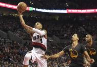 Feb 19, 2016; Portland, OR, USA; Portland Trail Blazers guard Damian Lillard (0) drives to the basket on Golden State Warriors guard Shaun Livingston (34) and center Marreese Speights (5) during the third quarter of the game at the Moda Center at the Rose Quarter. Lillard scored 51 points as the Blazers won 137-105. Mandatory Credit: Steve Dykes-USA TODAY Sports