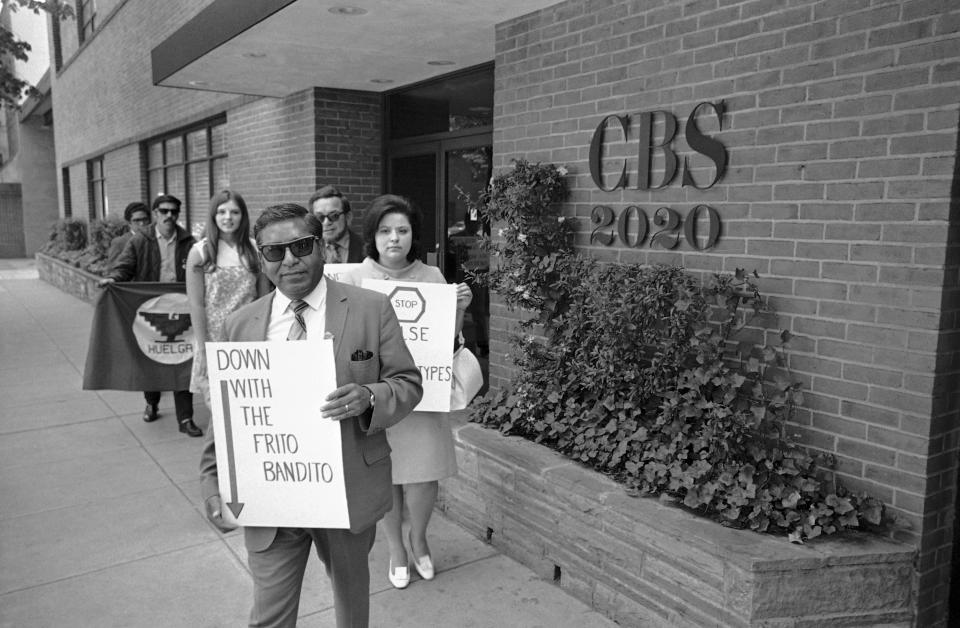 FILE - In this May 5, 1969, file photo, Armando Rodriguez, foreground, director of the Office of Education, part of the U.S. Department of Health, Education, and Welfare, lead demonstrators in front of the Columbia Broadcasting Company's Washington studios protest what they called "the mass media's continued discrimination and demeaning characterizations of Mexican-Americans." Rodriguez, a Mexican immigrant and World War II veteran went on served under four American presidents while pressing for civil rights, died Sunday, Feb. 17, 2019. He was 97. (AP Photo/Bob Daugherty, File)