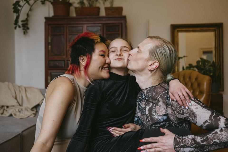 Some trans women find euphoria in their role as mothers. <a href="https://www.gettyimages.com/detail/photo/happy-lgbtqia-couple-kissing-daughter-at-home-royalty-free-image/1421318476" rel="nofollow noopener" target="_blank" data-ylk="slk:Maskot/DigitalVision via Getty Images;elm:context_link;itc:0;sec:content-canvas" class="link ">Maskot/DigitalVision via Getty Images</a>