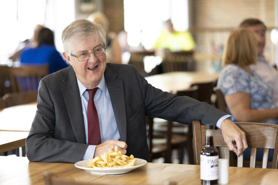 CWMBRAN, WALES - AUGUST 03: First Minister of Wales Mark Drakeford visits Page's fish and chip shop restaurant on August 3, 2020 in Cwmbran, Wales. Coronavirus lockdown measures continue to be eased as the number of excess deaths in Wales falls below the five-year average. From today up to 30 people can meet outdoors and pubs, restaurants and cafes can open to customers indoors. (Photo by Matthew Horwood/Getty Images)