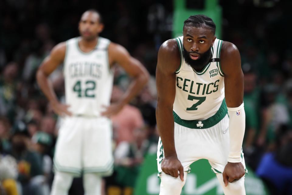 Boston Celtics' Jaylen Brown (7) watches a Miami Heat player shoot a free throw during the second half of Game 3 of the NBA basketball playoffs Eastern Conference finals Saturday, May 21, 2022, in Boston. The Heat won 109-103. (AP Photo/Michael Dwyer)