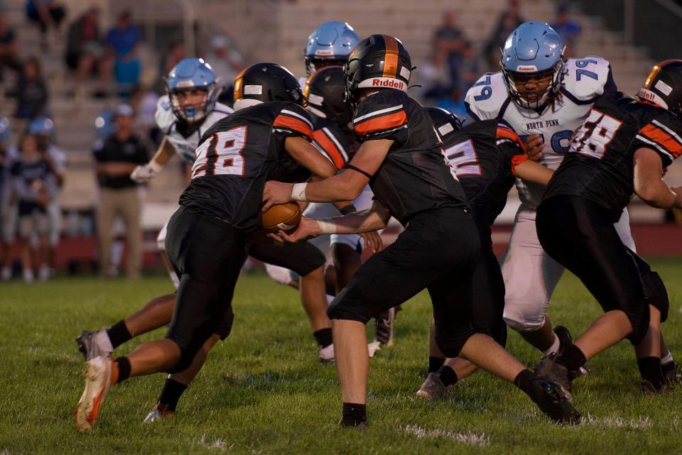 Pennsbury's Nathan Beighley hands the ball to running back Shawn Secrest on Friday, Sept 10, 2021. North Penn defeated Pennsbury 35-0.