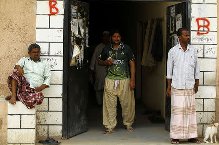 Asian workers stand at their accommodation in Qadisiya labour camp, Saudi Arabia August 17, 2016. Picture taken August 17, 2016. REUTERS/Faisal Al Nasser