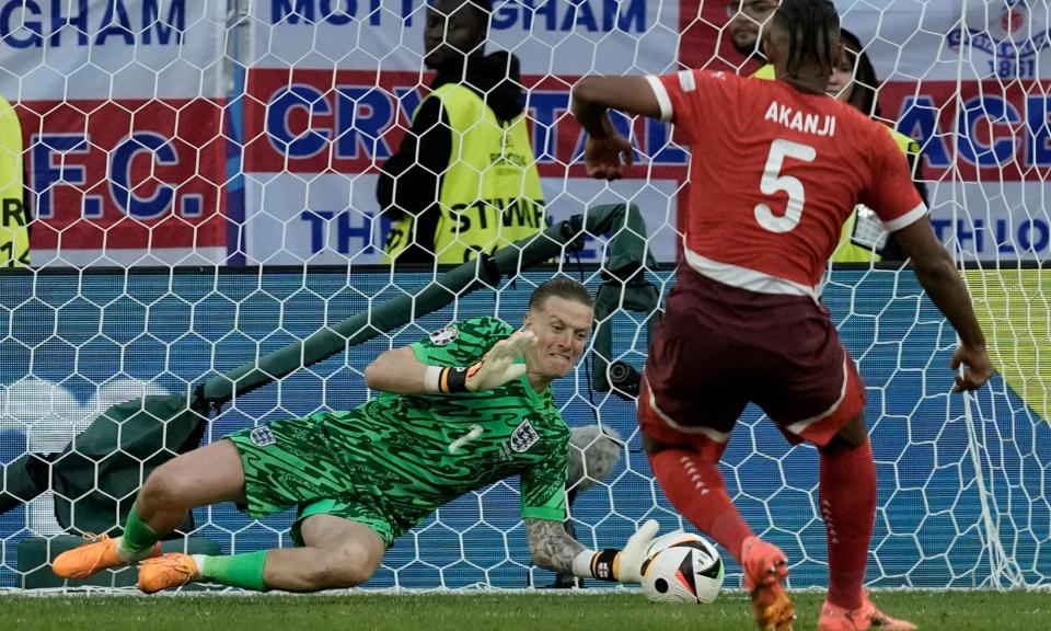 <span>Jordan Pickford makes a save from Switzerland's Manuel Akanji. The goalkeeper was England’s hero of the penalty shootout.</span><span>Photograph: Thanassis Stavrakis/AP</span>