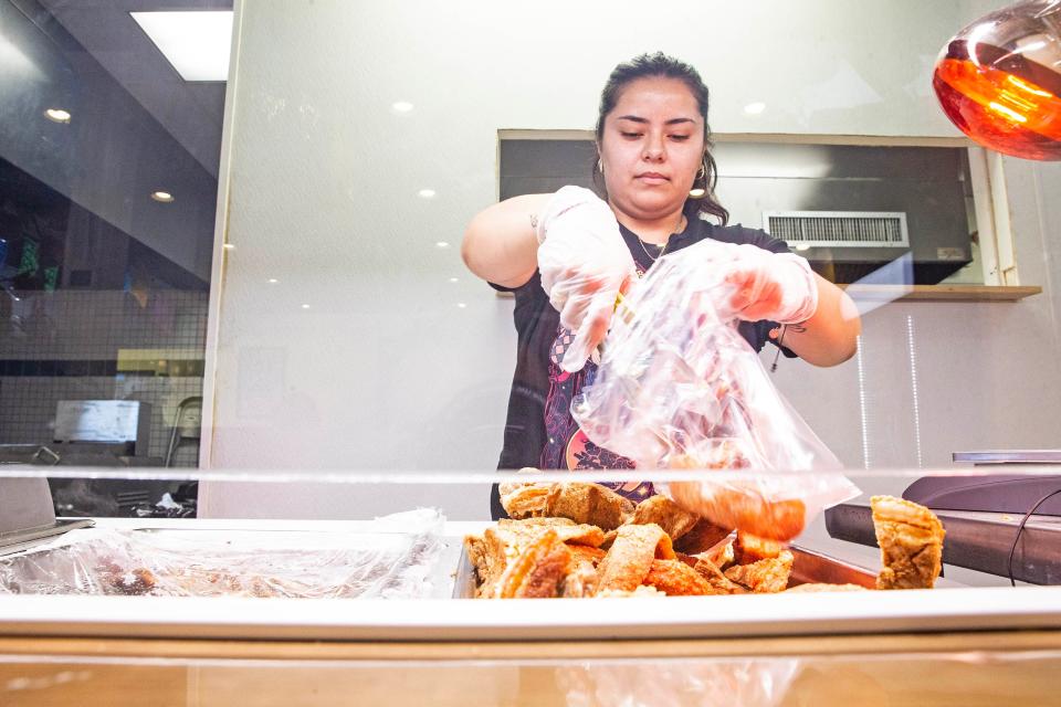 Maria Morales, co-owner, bags some "chicharron" at Tortilleria Dos Milpas in Elsmere, Tuesday, Oct. 24, 2023. Dos Milpas makes tortillas from nixtamalized corn, with Michoacan-style carnitas, and is part of the reason why northern Delaware is deemed to have some of the best Mexican food in the region.