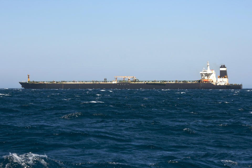 Renamed Adrian Aryra 1 super tanker hosting an Iranian flag in the British territory of Gibraltar, Sunday, Aug. 18, 2019. Authorities in Gibraltar on Sunday rejected the United States' latest request not to release a seized Iranian supertanker, clearing the way for the vessel to set sail after being detained last month for allegedly attempting to breach European Union sanctions on Syria. (AP Photo/Marcos Moreno)