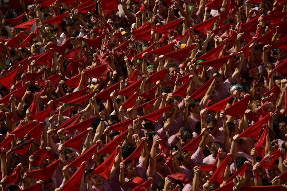 <p>Revelers hold up neckties during the launch of the <em>chupinazo</em> rocket to celebrate the official opening of the 2017 San Fermín Fiesta. (Photo: Alvaro Barrientos/AP) </p>