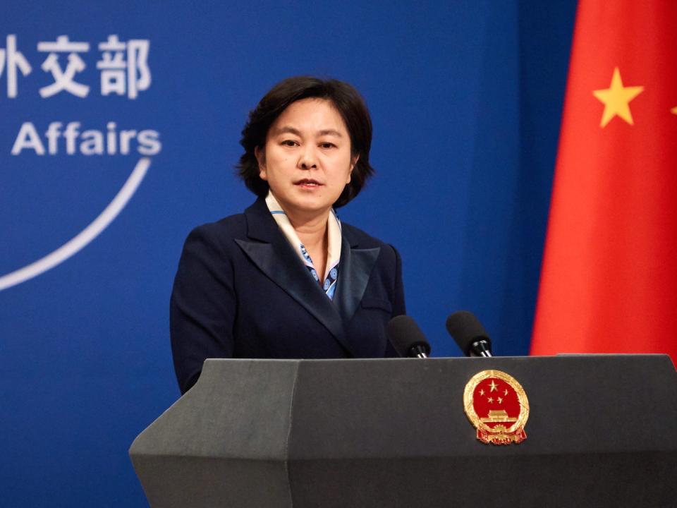 The Chinese Foreign Ministry spokesperson Hua Chunying stands at a podium in front of a Chinese flag.